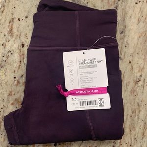 NWT:  Athleta girls “stash your treasures tight”.  Size 12.  Deep purple color.